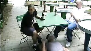 Foot Domination in Public: Two Dudes Use Their Buddy Under the Table